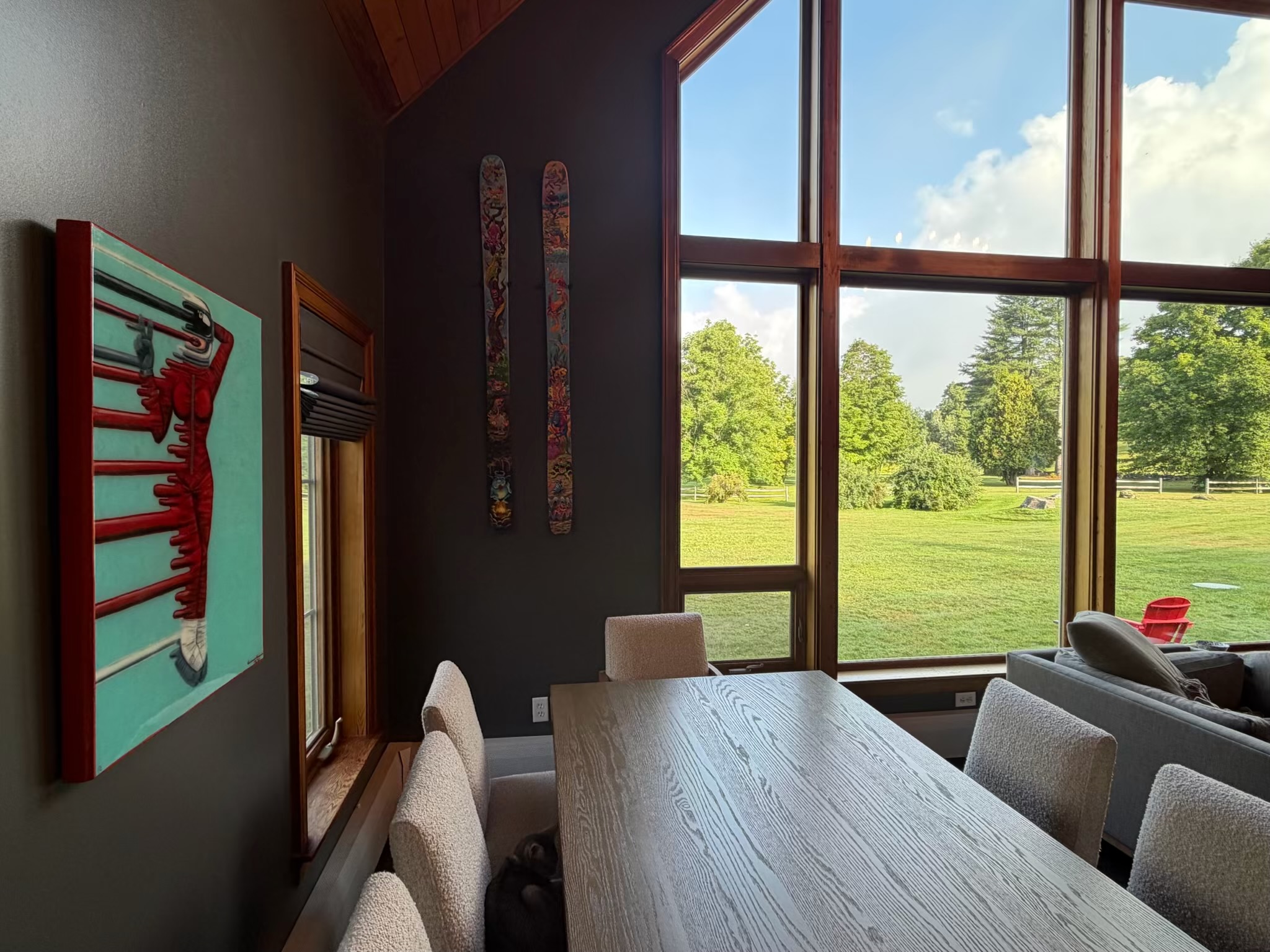 Art-filled dining room with skis and landscape view